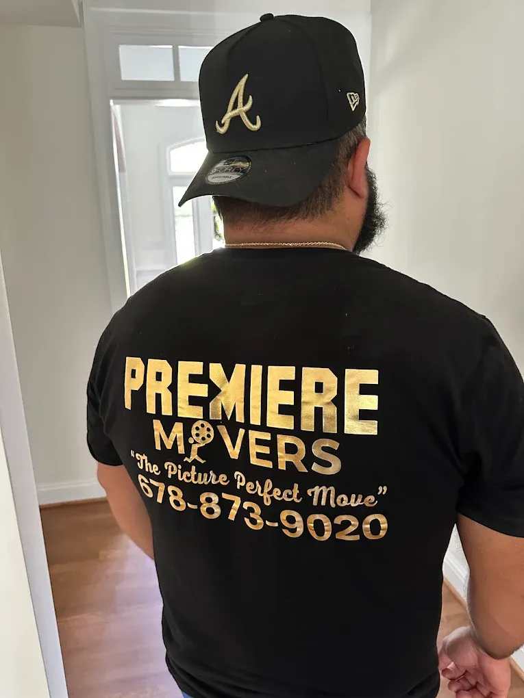 The back of a Premiere Movers branded shirt reading The Picture Perfect Move